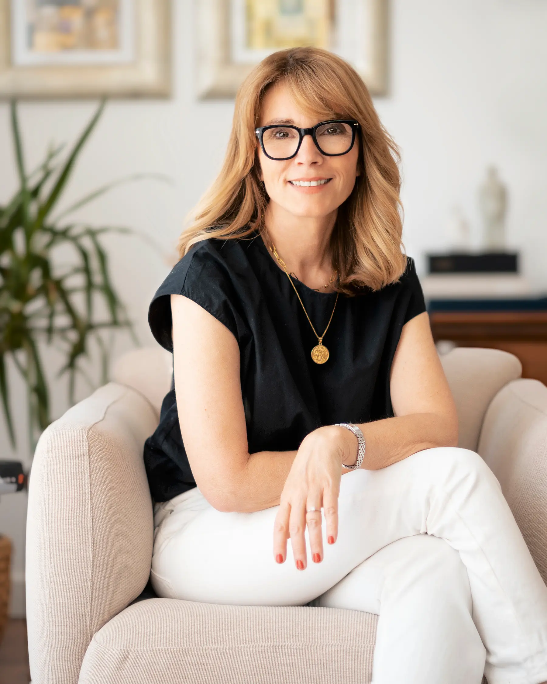 Confident woman in her late 40s relaxed at home in Augusta, GA, a good candidate for BodyTite skin tightening and body contouring